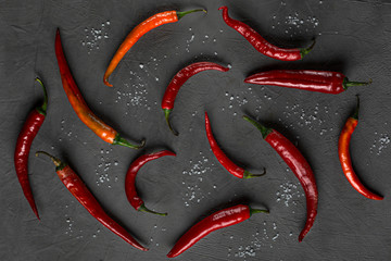 Vibrant red chili pepper isolated on a dark background