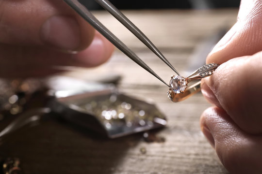 Male Jeweler Examining Diamond Ring In Workshop, Closeup View