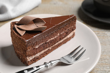 Delicious fresh chocolate cake served on wooden table, closeup