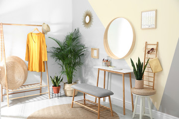 Stylish room interior with little table and comfortable bench