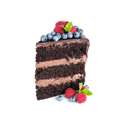 Piece of delicious chocolate cake decorated with fresh berries on white background