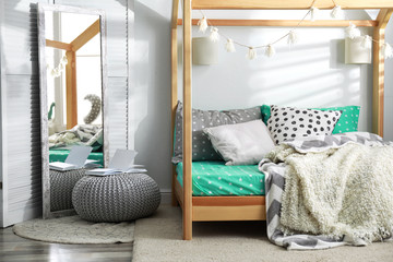 Cozy child room interior with comfortable bed