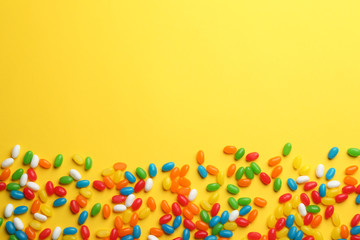 Tasty colorful jelly beans on yellow background, flat lay. Space for text - Powered by Adobe
