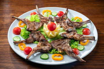Juicy baked ribs with pork and veal meat. With vegetables.