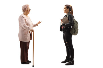 Senior woman with a walking cane standing and talking to a female student
