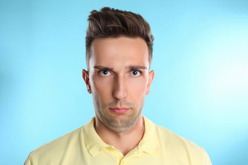 Obraz premium Young man with double chin on blue background