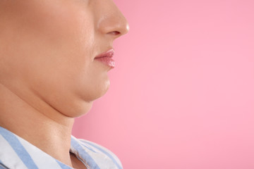 Young woman with double chin on pink background, closeup. Space for text - obrazy, fototapety, plakaty