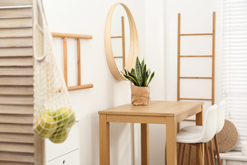 Stylish room interior with wooden table and bar stools