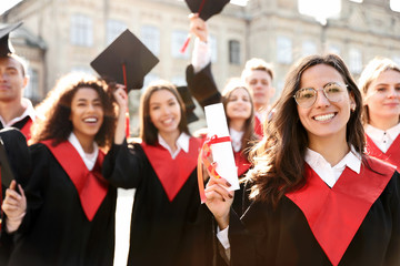 Group of happy students outdoors. Graduation ceremony