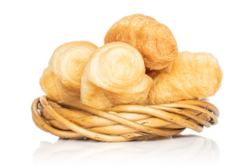Group of four whole fresh baked mini croissant in wicker vine circle isolated on white background