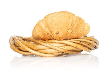 One whole fresh baked mini croissant in wicker vine circle isolated on white background
