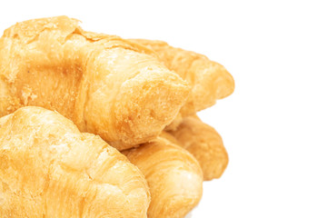 Lot of whole fresh baked mini croissant closeup isolated on white background