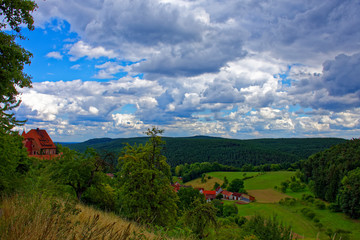 Beautiful sky with clouds over the city near the forest