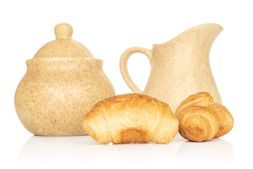Group of two whole fresh baked mini croissant with sugar bowl and ceramic jug isolated on white background