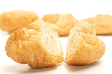 Group of one whole two halves of fresh baked mini croissant one sliced isolated on white background