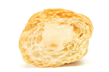 One half of fresh baked mini croissant isolated on white background