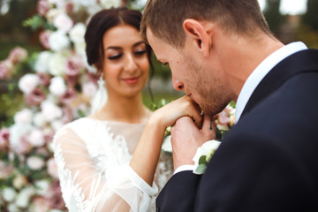 Wedding engagement rings. Married couple exchange wedding rings at a wedding ceremony. Groom put a ring on finger of his lovely wife. Concept wedding details. Happy family. Together.