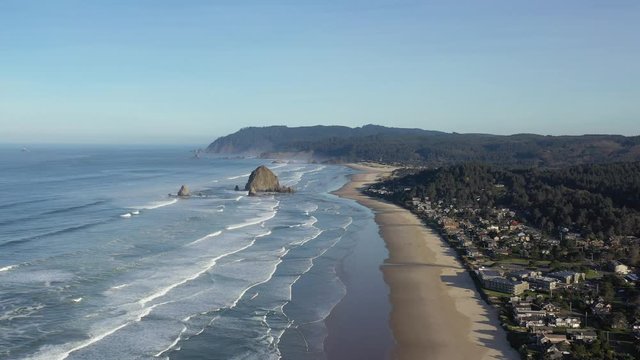 Haystack Rock at Cannon Beach in Oregon. Aerial 4K footage of ocean, beach and coast.