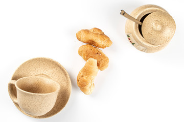 Group of three whole fresh baked mini croissants office breakfast flatlay isolated on white background