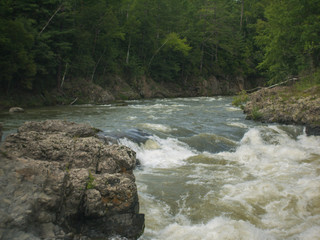 Mountain rapid river with rocky shores threshold