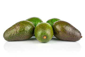 Group of five whole fresh green avocado isolated on white background