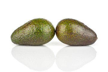 Group of two whole fresh green avocado isolated on white background