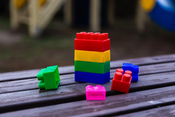 Colorful toy building blocks or bricks On wood background.