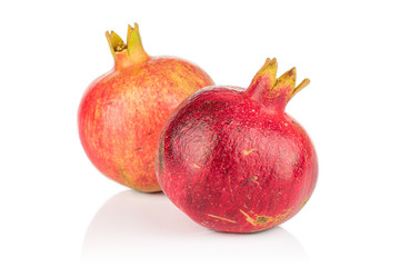 Group of two whole fresh red pomegranate isolated on white background