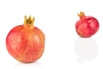 Group of two whole fresh red pomegranate e isolated on white background