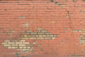 Bright textured painted red brick wall
