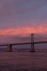 Fototapeta na wymiar Fire red sunset behind the Bay Bridge