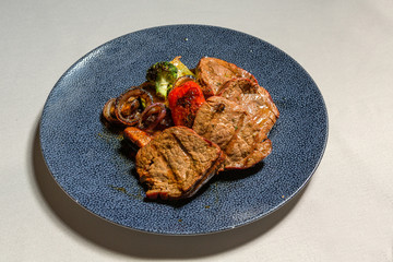 Grilled beef steak with griled vegetables served in a restaurant