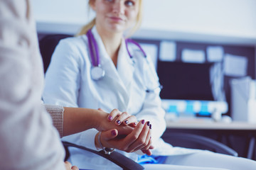 Doctor or nurse holding elderly lady's hands