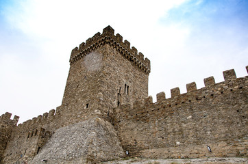 Tower of an old medieval fortress in the mountains.
