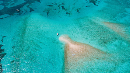 boat anchored Private Mermaid tail shaped Island in Florida Keys - obrazy, fototapety, plakaty