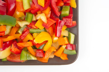 Colored sweet fresh pepper sliced ​​on a plate. Vitamin and healthy food.