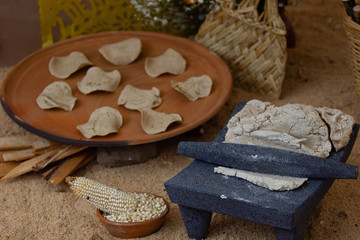 a handmade stone metate, with dough ready for making tortillas, tortilla making process