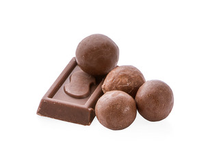 Milk organic chocolate pieces isolated on white background