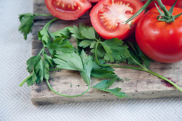 Direct overhead view close up with selective focus on corner of cutting board with fresh home grown pesticide free green parsley garnish