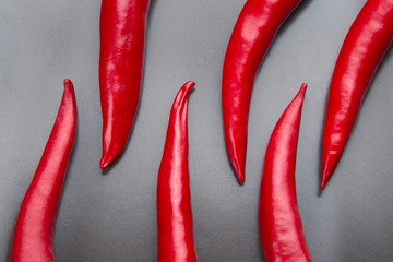 Red hot pepper close-up on gray background. Healthy food and vitamins.