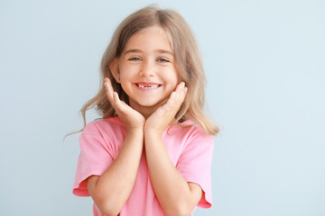 Cute little girl on light background