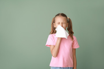 Little girl suffering from allergy on color background