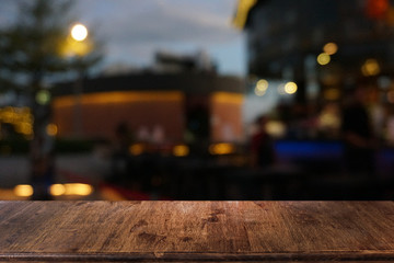 Empty dark wooden table in front of abstract blurred bokeh background of restaurant . can be used for display or montage your products.Mock up for space.