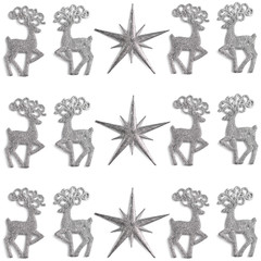christmas pattern made of stars and silver color toys deer on white background. winter concept, flat lay, top view