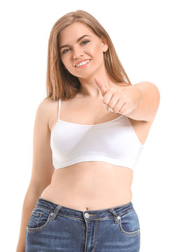 Young body positive woman showing thumb-up on white background