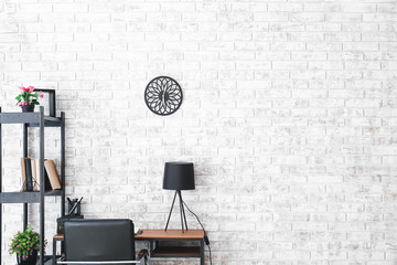 Modern stylish workplace near brick wall
