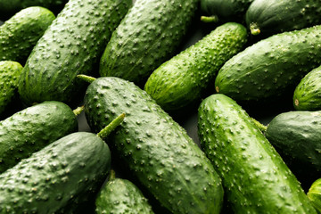 Fresh green cucumbers as background