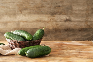 Fresh green cucumbers on wooden background