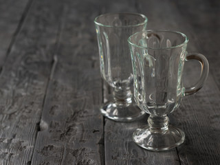 Two empty coffee glasses on the wooden table.