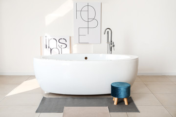 Modern ceramic bathtub in light interior